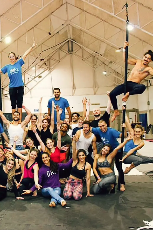 A group of people inside a gymnasium, posing for the camera.